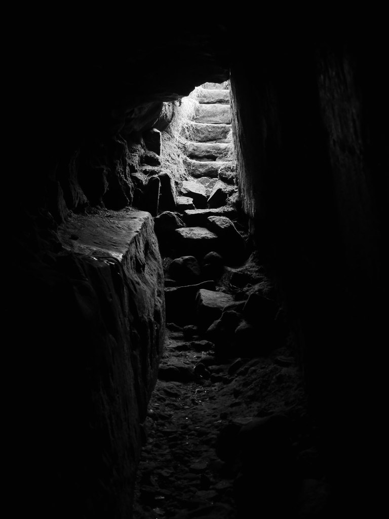 Light down stone steps from in a cave